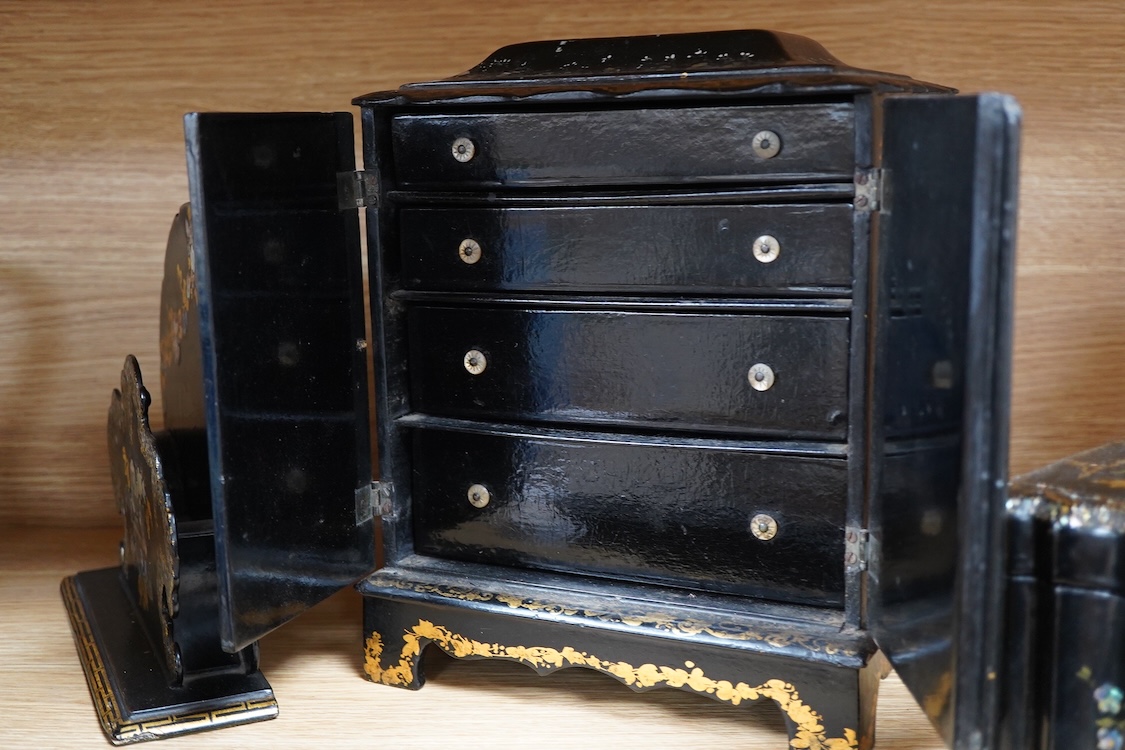 Four 19th century mother of pearl inlaid papier mache items, to include, a four drawer cabinet, 26.5cm high, a tea caddy, letter rack and pen dish